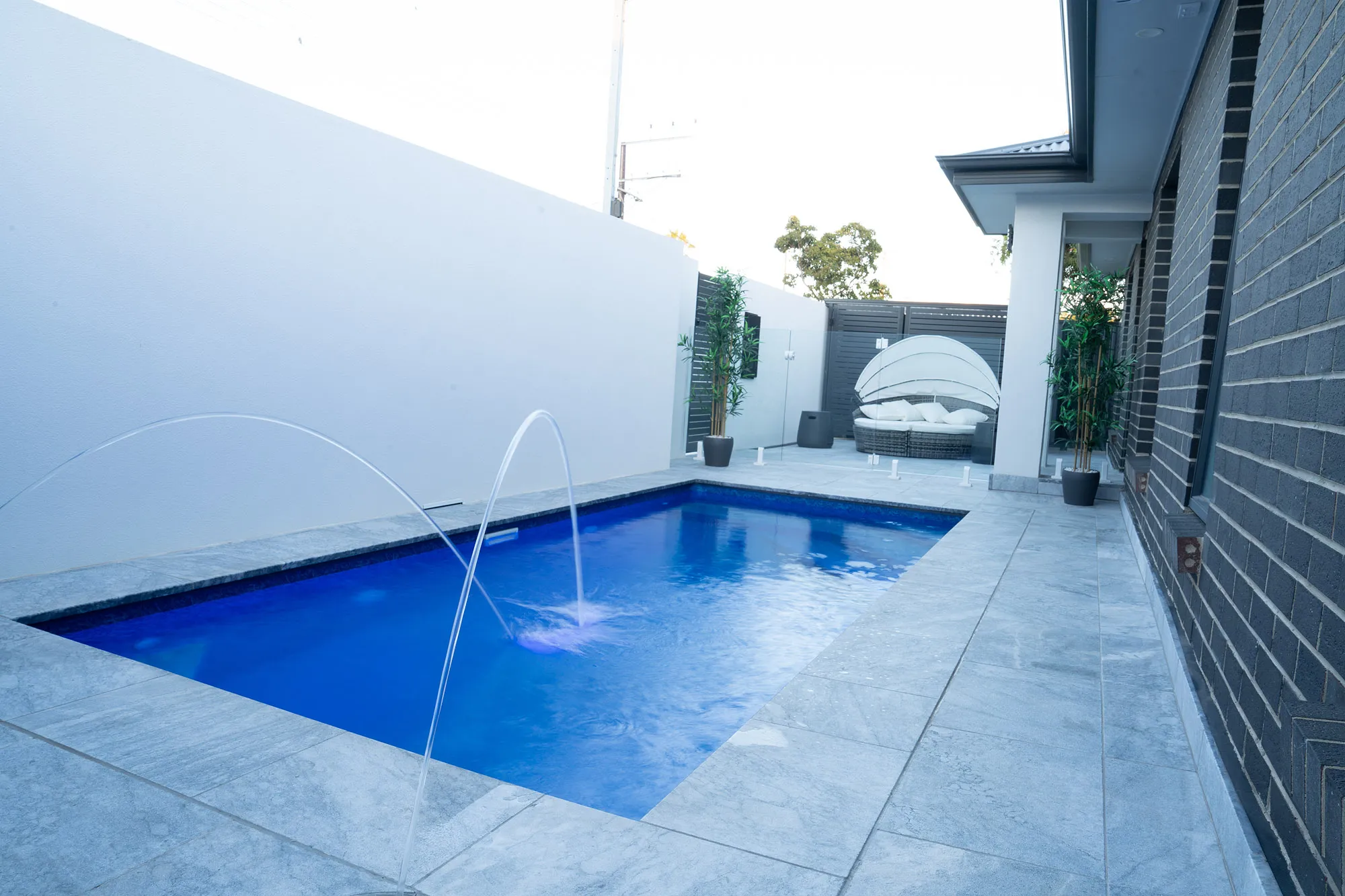 Adelaide Hybrid Pools plunge pool with twin Pentair MagicStream laminar jets running and outdoor daybed in background