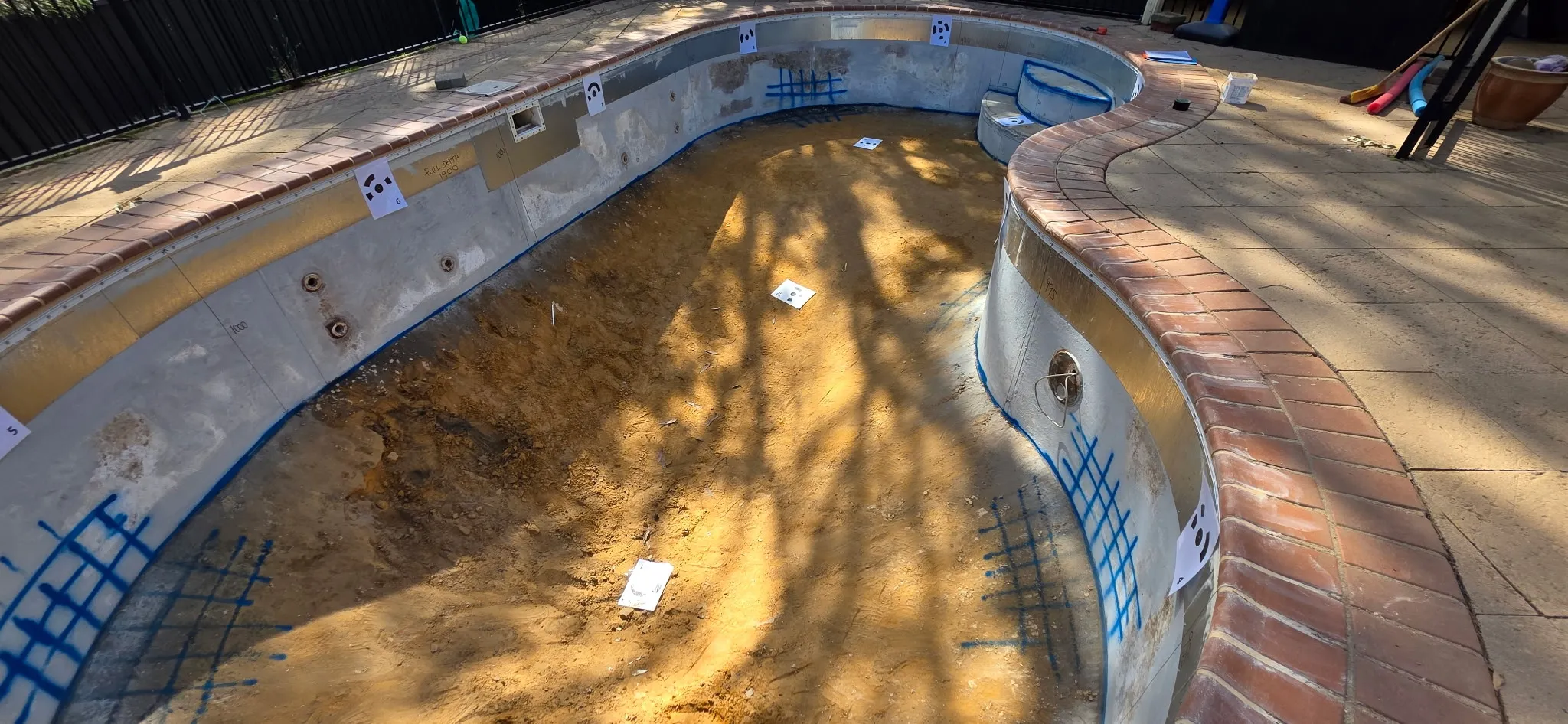 3D measurement markers placed around pool shell deep end for precision liner fabrication at Coromandel Valley
