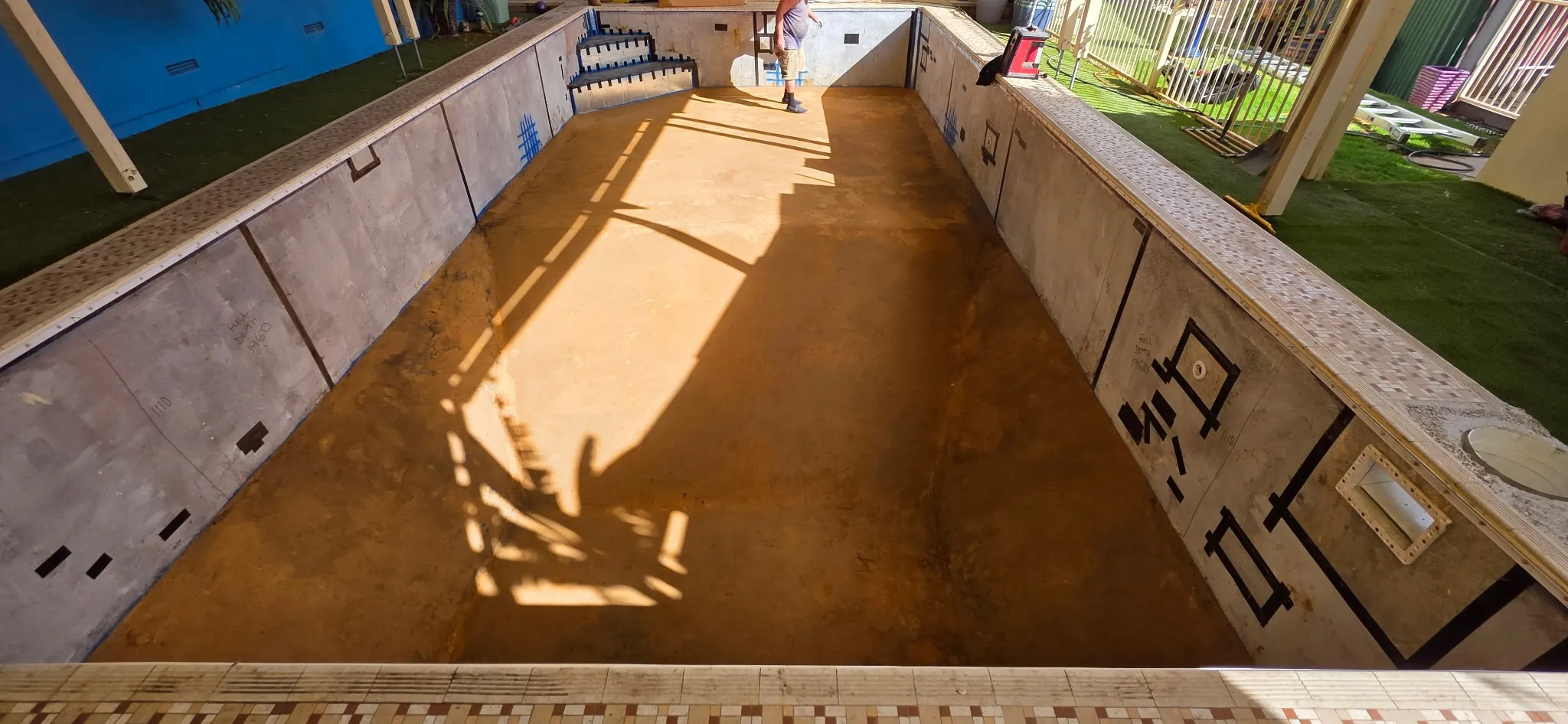 Pool shell prepared for new liner at Morphett Vale showing steel panels and resurfaced sand base