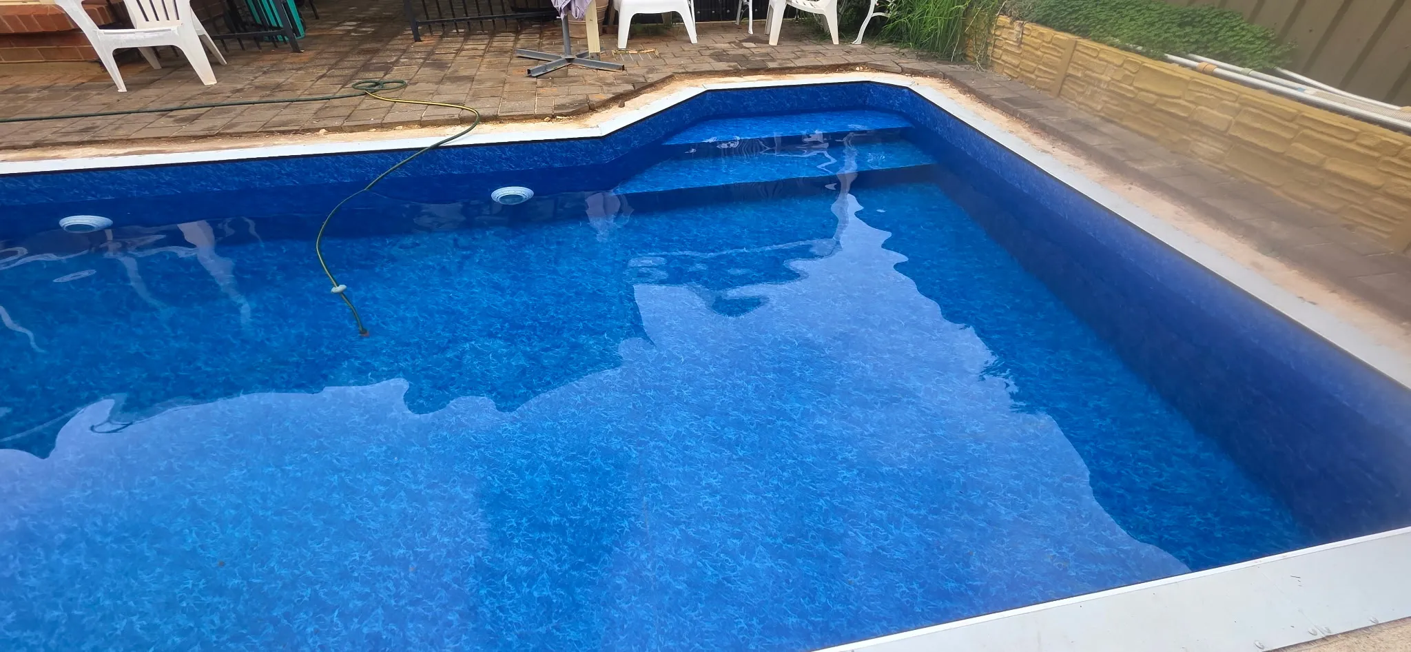 Step entry detail of finished pool showing Maui liner over high density foam steps with LED pool lights
