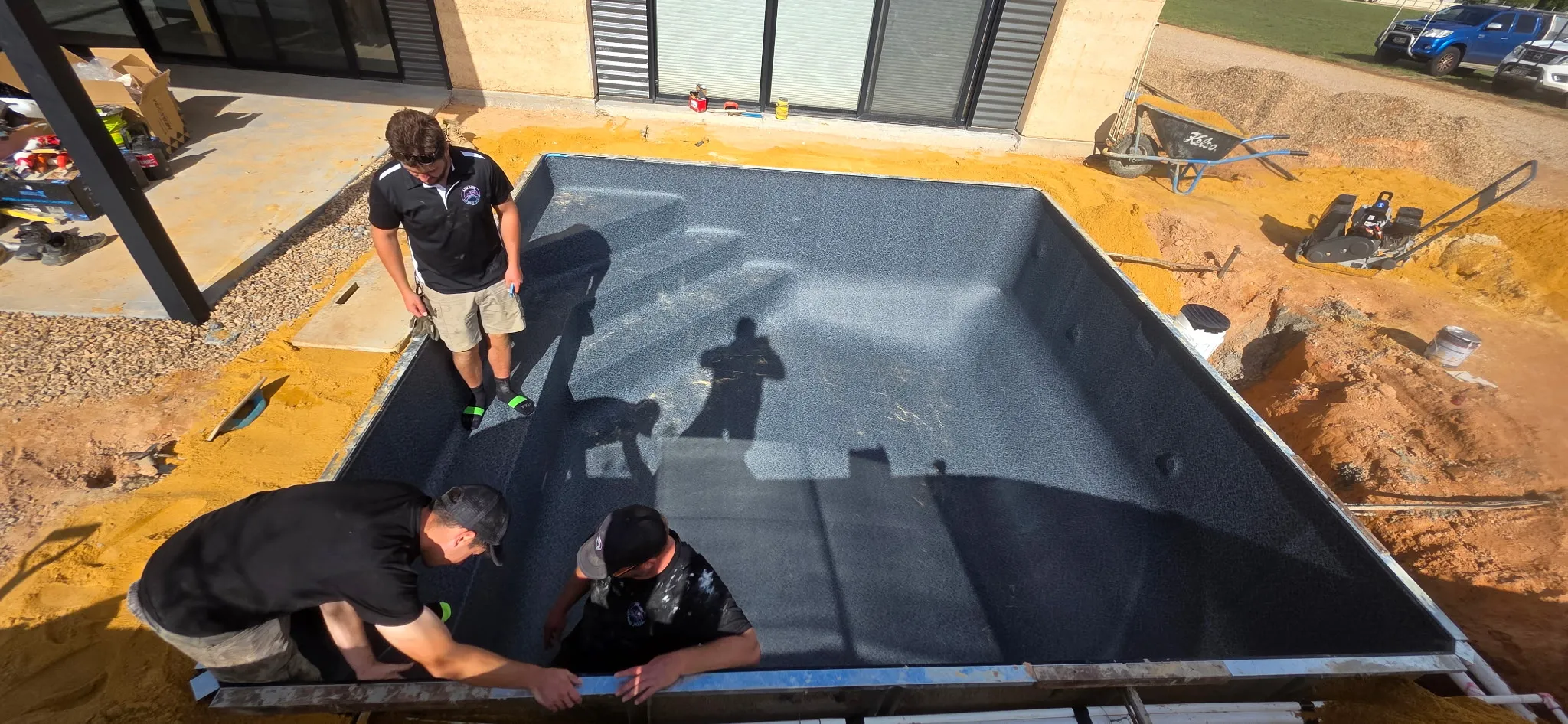 Adelaide Hybrid Pools team installing Aqualux Antique Black liner from elevated angle