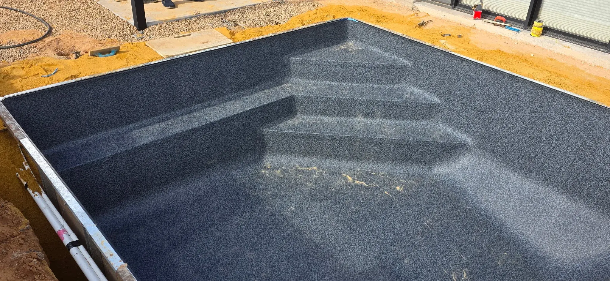 Antique Black liner installed showing 3 step corner entry detail before water fill