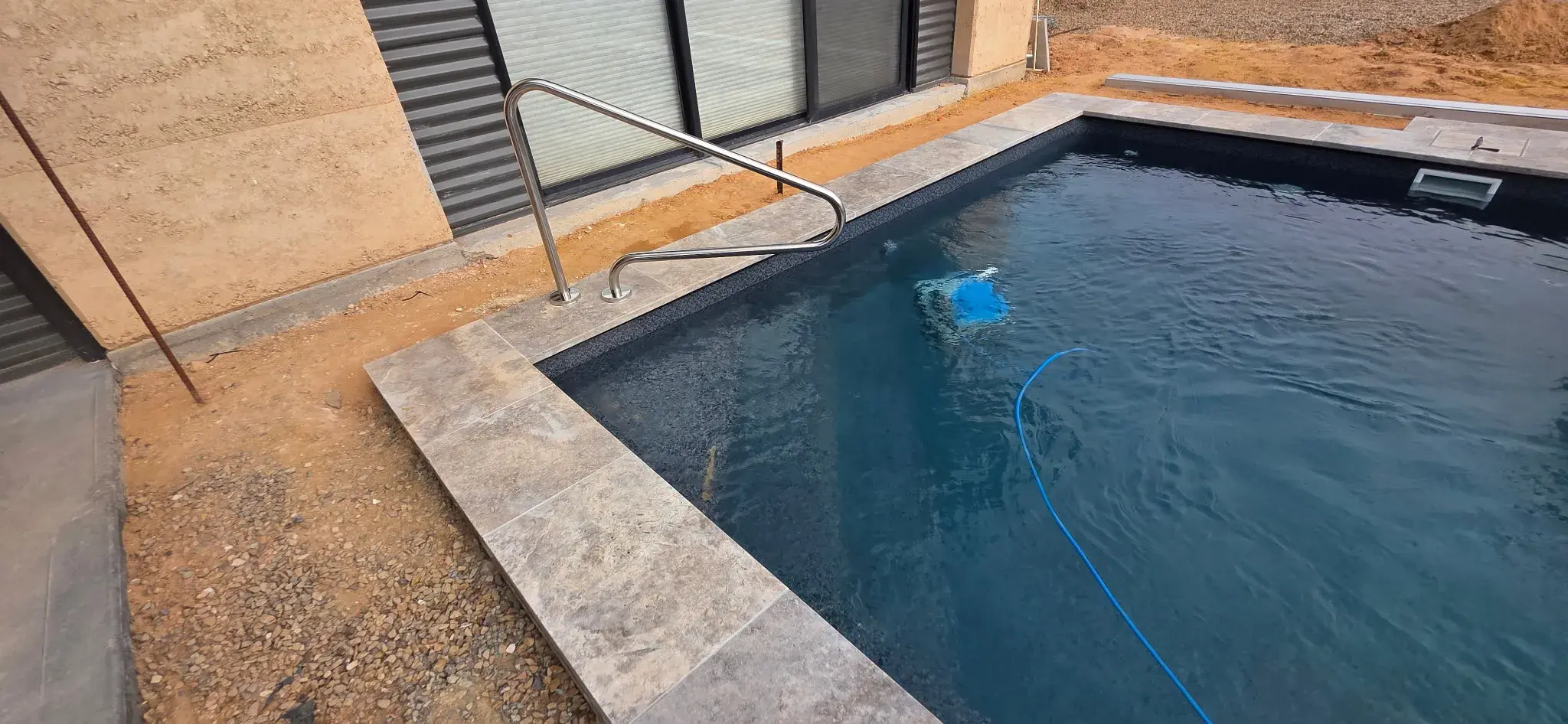 SR Smith stainless steel handrail detail mounted on Stonecraft Luna travertine coping