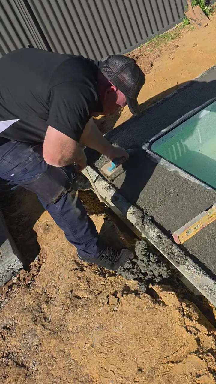 Concrete bond beam trowelled smooth around the pool edge at Roseworthy