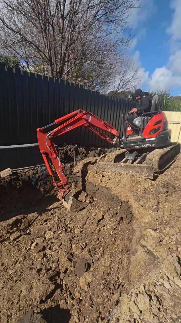 Excavator digging the pool site for a new inground pool at Woodcroft