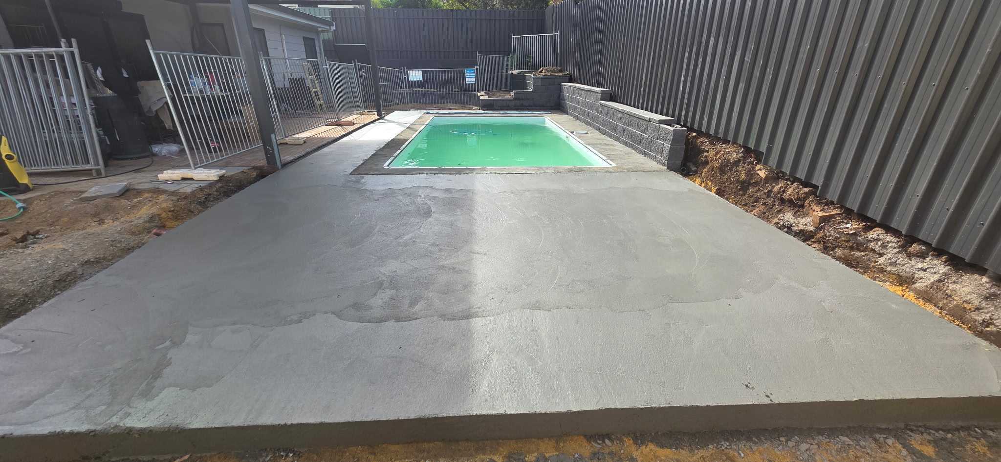 Newly completed concrete pool area in Woodcroft